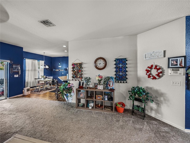 2033 Normandy Heights Dr, Winter Haven, FL 33880 - carpeted living area with baseboards, a textured ceiling, and recessed lighting