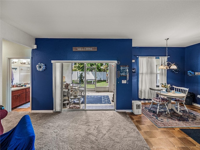 2033 Normandy Heights Dr, Winter Haven, FL 33880 - dining space featuring a chandelier, a textured wall, and baseboards
