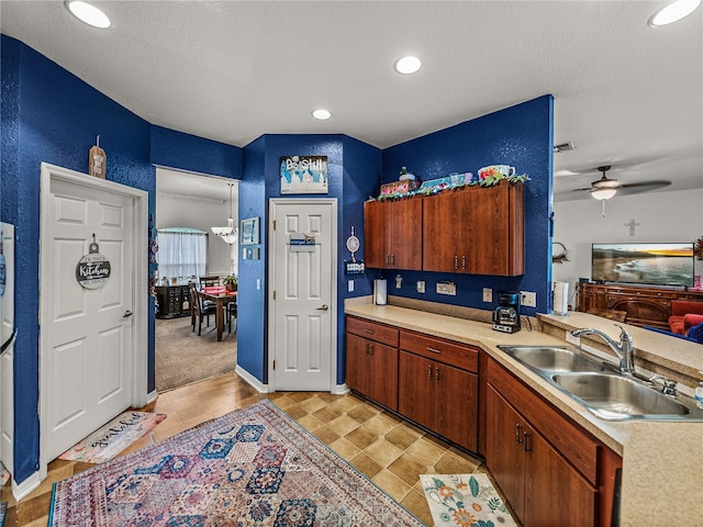 2033 Normandy Heights Dr, Winter Haven, FL 33880 - kitchen featuring a sink, light countertops, a ceiling fan, a textured wall, and a textured ceiling