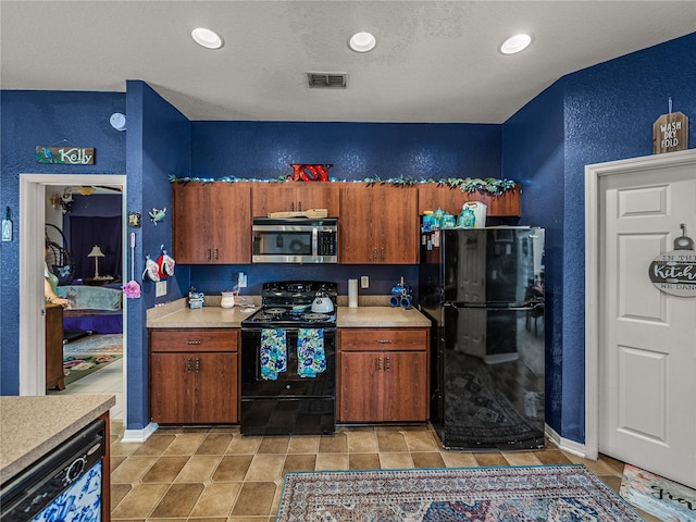 2033 Normandy Heights Dr, Winter Haven, FL 33880 - kitchen featuring black appliances, a textured wall, light countertops, brown cabinets, and recessed lighting