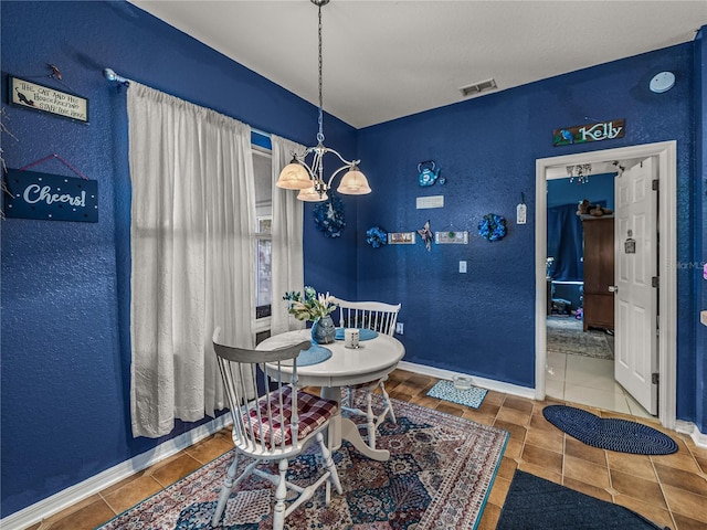 2033 Normandy Heights Dr, Winter Haven, FL 33880 - tiled dining space with baseboards, a textured wall, and a chandelier