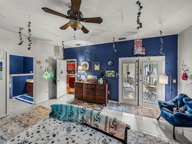 2033 Normandy Heights Dr, Winter Haven, FL 33880 - bedroom with tile patterned floors, access to outside, a textured ceiling, connected bathroom, and ceiling fan