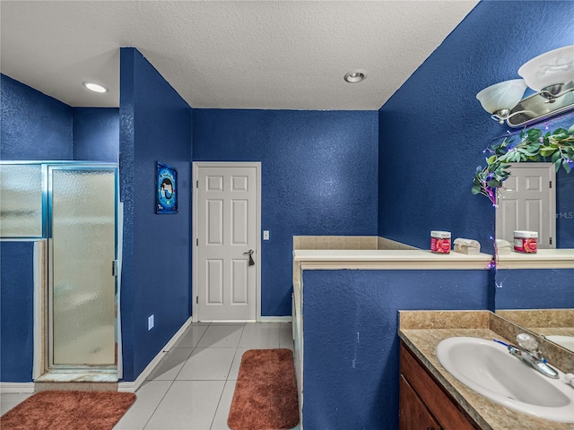 2033 Normandy Heights Dr, Winter Haven, FL 33880 - bathroom featuring tile patterned floors, a shower stall, vanity, a textured ceiling, and a textured wall