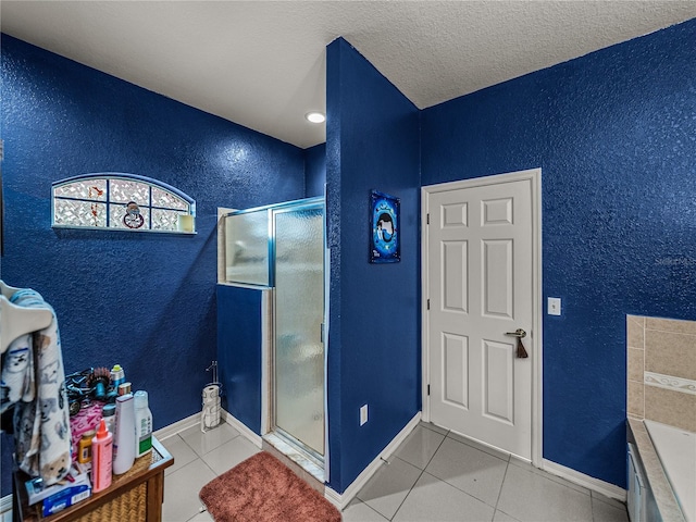 2033 Normandy Heights Dr, Winter Haven, FL 33880 - bathroom featuring a textured wall, a shower stall, tile patterned flooring, a bath, and a textured ceiling
