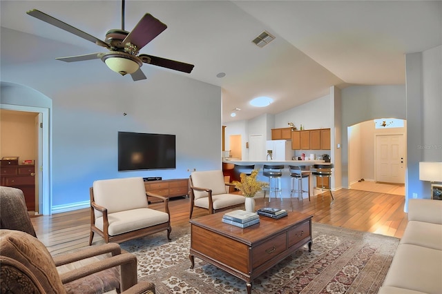 3684 Madbury Cir, Lakeland, FL 33810 - living area with a ceiling fan, arched walkways, light wood-style flooring, lofted ceiling, and visible vents