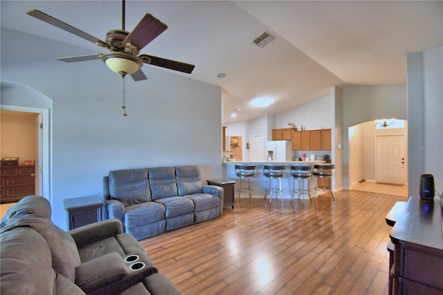 3684 Madbury Cir, Lakeland, FL 33810 - living area featuring a ceiling fan, wood finished floors, arched walkways, lofted ceiling, and visible vents