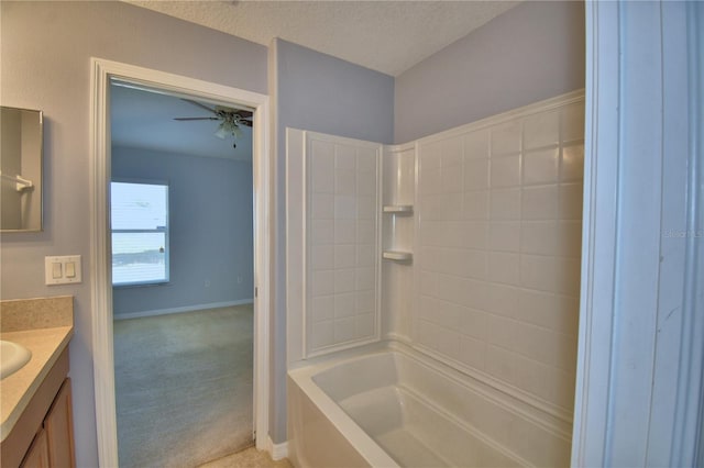 3684 Madbury Cir, Lakeland, FL 33810 - full bathroom featuring a textured ceiling, bathtub / shower combination, baseboards, ceiling fan, and vanity