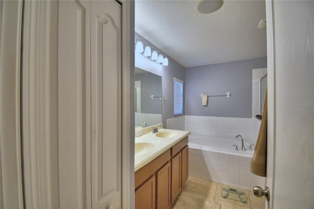 3684 Madbury Cir, Lakeland, FL 33810 - full bath featuring tile patterned flooring, a garden tub, double vanity, a sink, and a textured ceiling