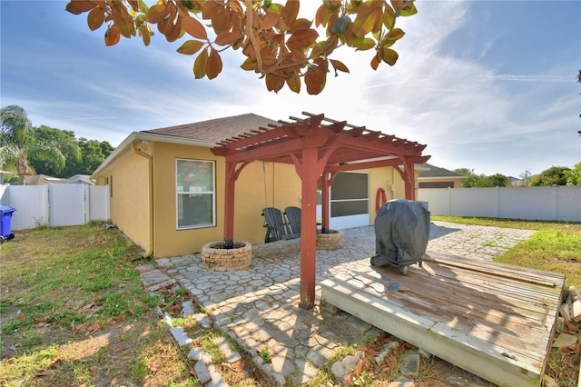 3684 Madbury Cir, Lakeland, FL 33810 - exterior space with a pergola, a patio area, a fire pit, a fenced backyard, and stucco siding