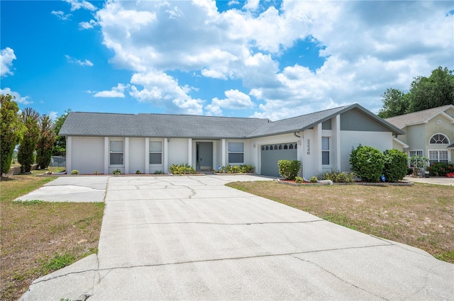 3226 Cherry Hill Cir S, Lakeland, FL 33810 - ranch-style house with an attached garage, stucco siding, driveway, and a front lawn