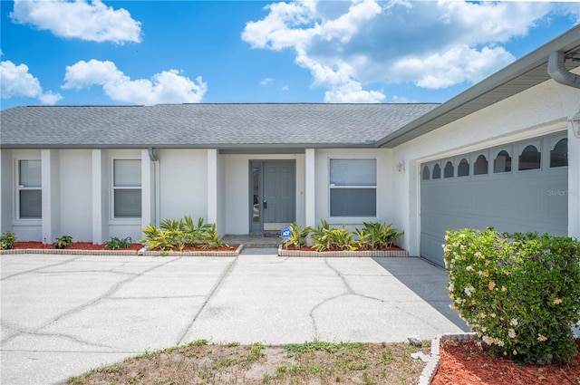 3226 Cherry Hill Cir S, Lakeland, FL 33810 - ranch-style home with an attached garage, roof with shingles, stucco siding, and concrete driveway