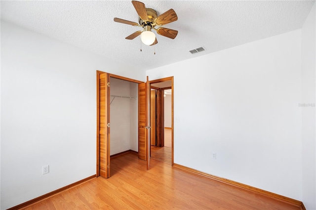 3226 Cherry Hill Cir S, Lakeland, FL 33810 - unfurnished bedroom featuring visible vents, a closet, baseboards, a textured ceiling, and light wood-style flooring