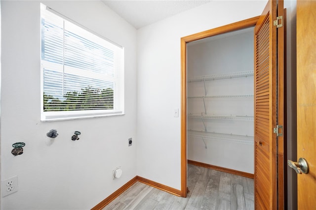 3226 Cherry Hill Cir S, Lakeland, FL 33810 - clothes washing area with laundry area, electric dryer hookup, baseboards, and light wood-style floors