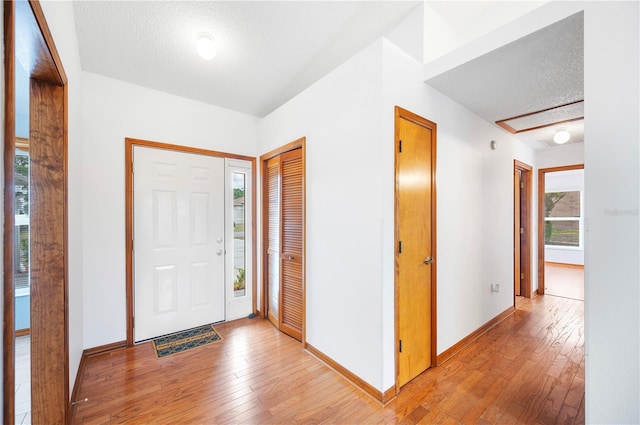 3226 Cherry Hill Cir S, Lakeland, FL 33810 - foyer with a textured ceiling, baseboards, and light wood-style floors