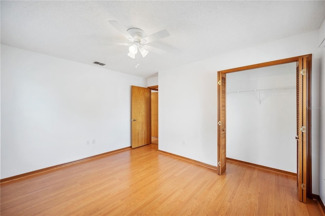3226 Cherry Hill Cir S, Lakeland, FL 33810 - unfurnished bedroom featuring visible vents, a closet, wood finished floors, baseboards, and a ceiling fan