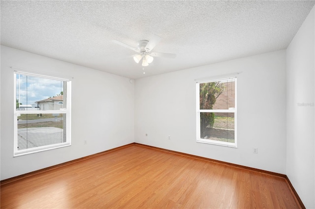 3226 Cherry Hill Cir S, Lakeland, FL 33810 - empty room with baseboards, a ceiling fan, a textured ceiling, and wood finished floors