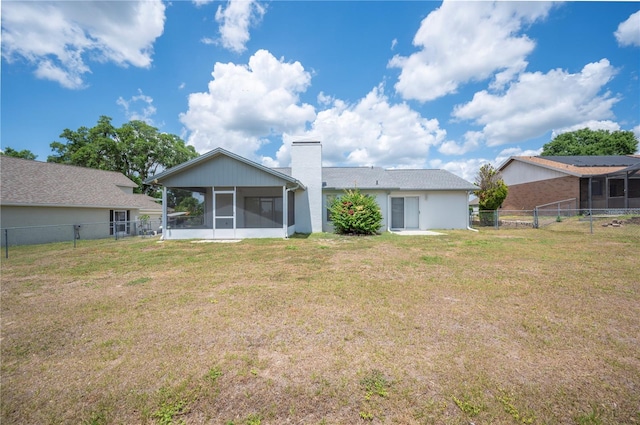 3226 Cherry Hill Cir S, Lakeland, FL 33810 - back of house featuring a lawn, a chimney, a fenced backyard, and a sunroom