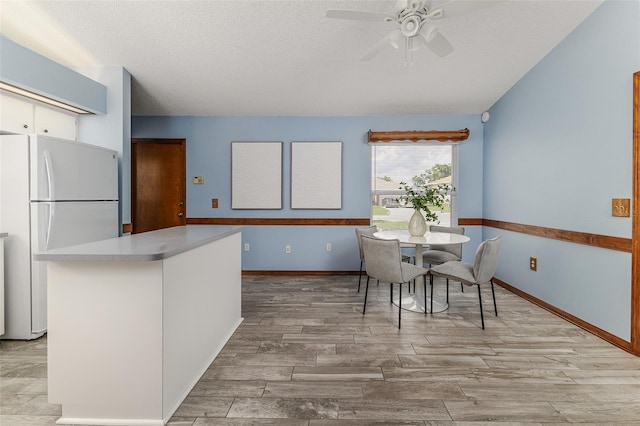 3226 Cherry Hill Cir S, Lakeland, FL 33810 - dining area with a ceiling fan, a textured ceiling, and light wood-style floors