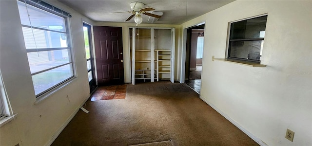 entrance foyer featuring plenty of natural light, carpet, and ceiling fan