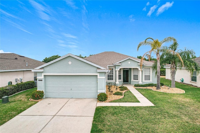 ranch-style home featuring a front lawn, an attached garage, concrete driveway, and stucco siding