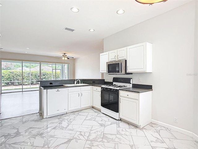 kitchen with visible vents, gas range gas stove, stainless steel microwave, a peninsula, and recessed lighting