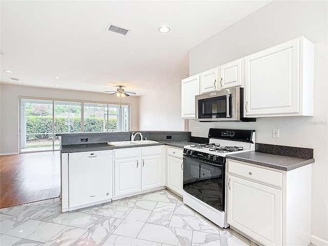 kitchen with range with gas cooktop, visible vents, dishwasher, a sink, and stainless steel microwave