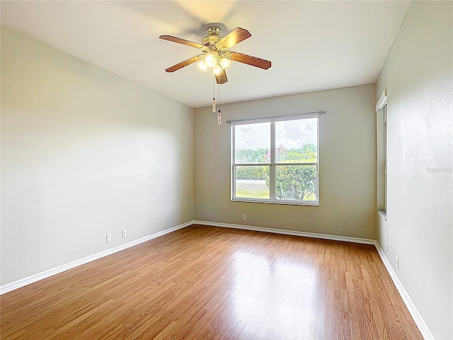 unfurnished room featuring baseboards, ceiling fan, and wood finished floors