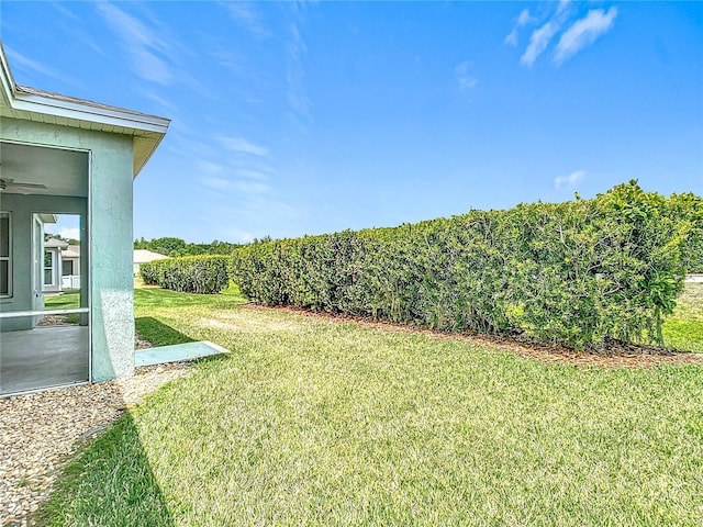 view of yard featuring a ceiling fan