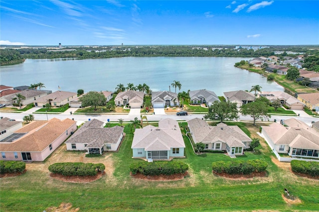 birds eye view of property with a water view and a residential view