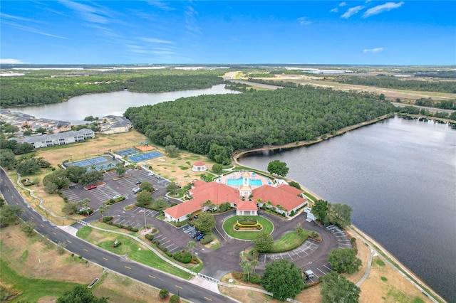 drone / aerial view with a water view and a forest view
