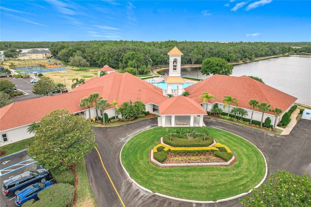 birds eye view of property with a water view and a wooded view