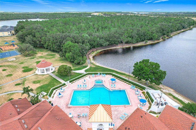 birds eye view of property with a water view and a wooded view