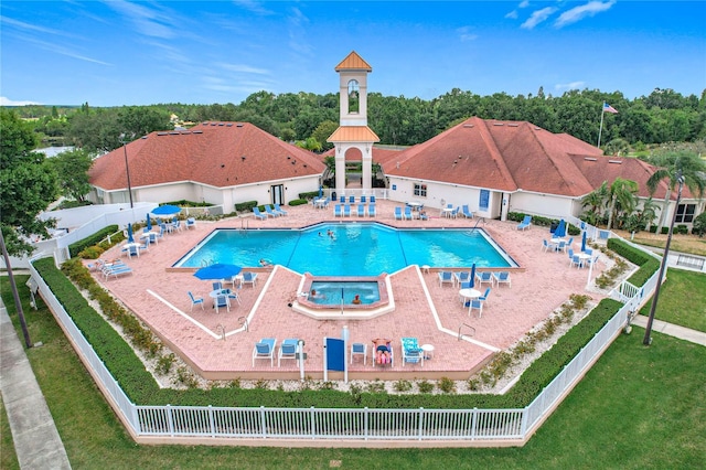 pool featuring a yard, fence, and a patio area