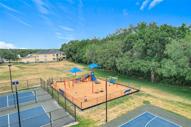 exterior space with fence, a yard, and a tennis court