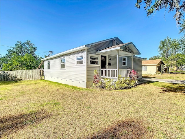 737 Kensington St, Lakeland, FL 33803 - view of front facade with fence, a porch, a front yard, and crawl space