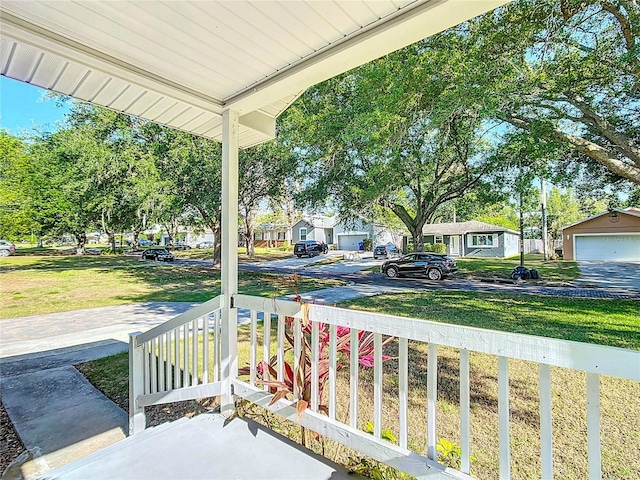 737 Kensington St, Lakeland, FL 33803 - view of patio / terrace featuring a residential view, a detached garage, and covered porch