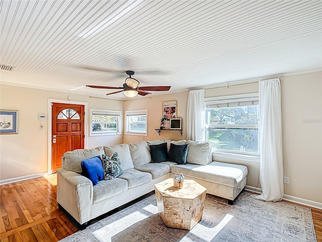 737 Kensington St, Lakeland, FL 33803 - living room featuring wood finished floors, ornamental molding, baseboards, visible vents, and a ceiling fan
