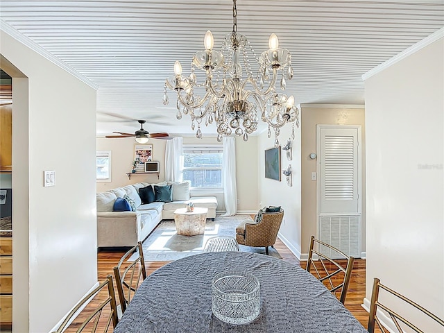 737 Kensington St, Lakeland, FL 33803 - dining room featuring baseboards, wood finished floors, ceiling fan with notable chandelier, and crown molding