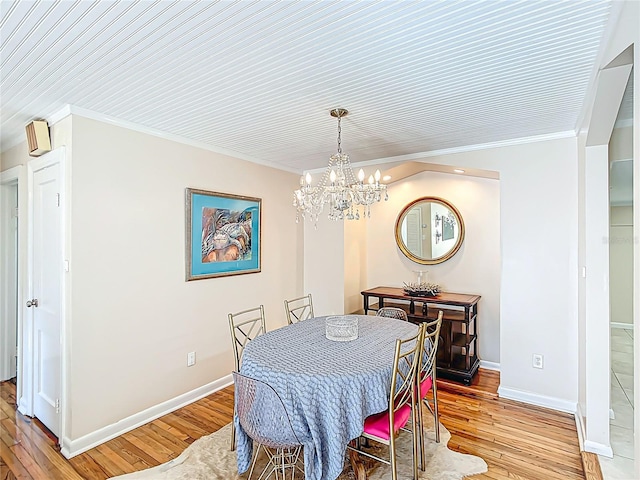 737 Kensington St, Lakeland, FL 33803 - dining room with an inviting chandelier, crown molding, light wood finished floors, and baseboards