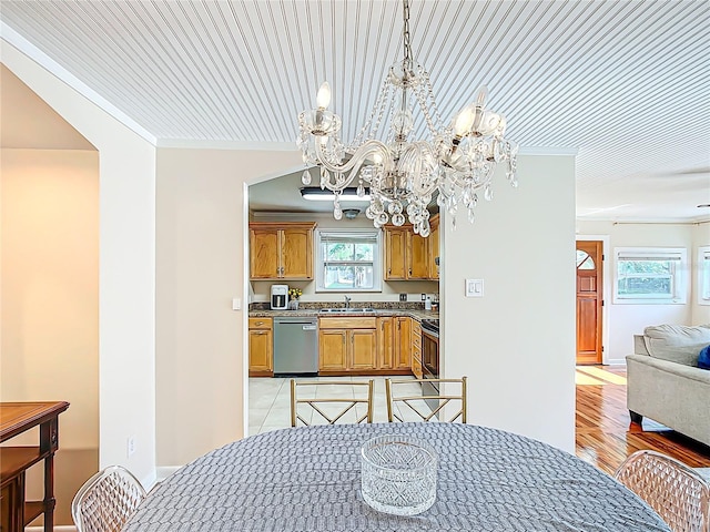 737 Kensington St, Lakeland, FL 33803 - dining area with ornamental molding, light wood-type flooring, and a notable chandelier