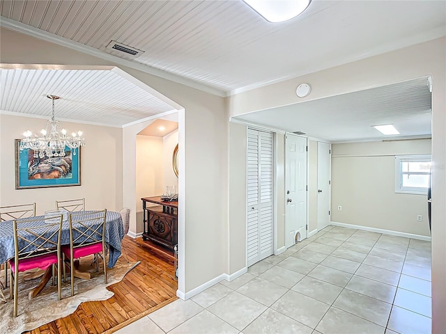 737 Kensington St, Lakeland, FL 33803 - dining room featuring baseboards, visible vents, a notable chandelier, and crown molding