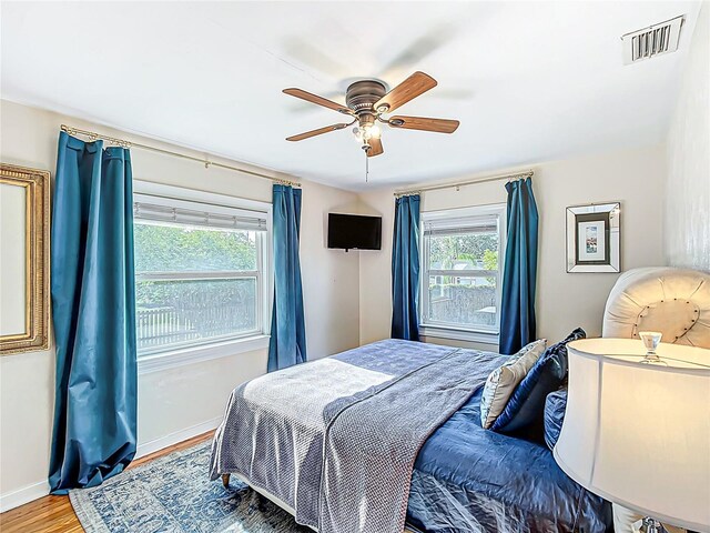 737 Kensington St, Lakeland, FL 33803 - bedroom featuring wood finished floors, visible vents, a ceiling fan, and baseboards