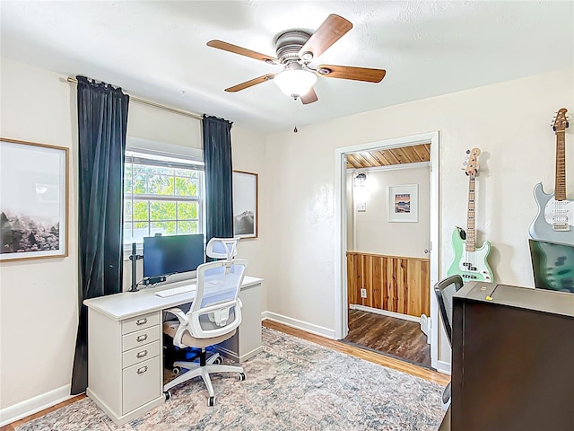 737 Kensington St, Lakeland, FL 33803 - office with a wainscoted wall, a ceiling fan, light wood-style flooring, and baseboards