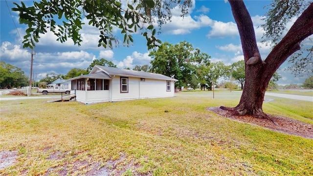 410 Orange St, Bradley, FL 33835 - view of property exterior with a lawn and a sunroom