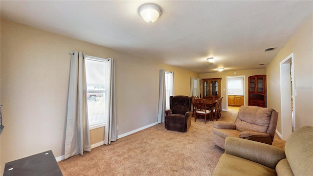 410 Orange St, Bradley, FL 33835 - living area with baseboards, visible vents, and light colored carpet
