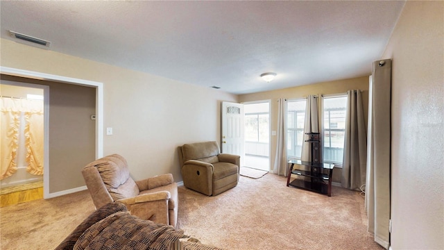 410 Orange St, Bradley, FL 33835 - living room with baseboards, visible vents, and light colored carpet