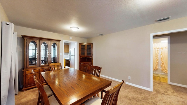 410 Orange St, Bradley, FL 33835 - dining area with a textured ceiling, baseboards, visible vents, and light colored carpet