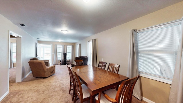 410 Orange St, Bradley, FL 33835 - dining area featuring light carpet, visible vents, and baseboards