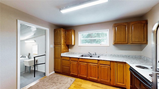 410 Orange St, Bradley, FL 33835 - kitchen with light countertops, brown cabinetry, electric stove, and a sink