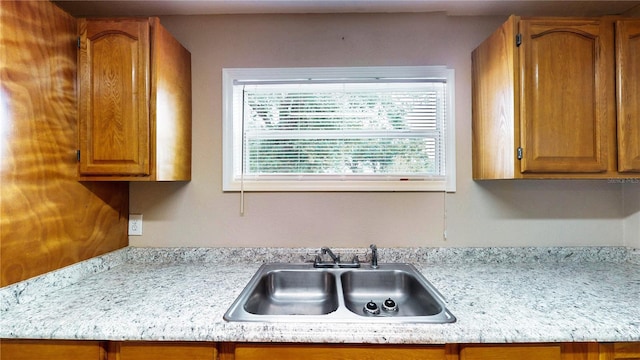 410 Orange St, Bradley, FL 33835 - kitchen with light countertops, a sink, and brown cabinets